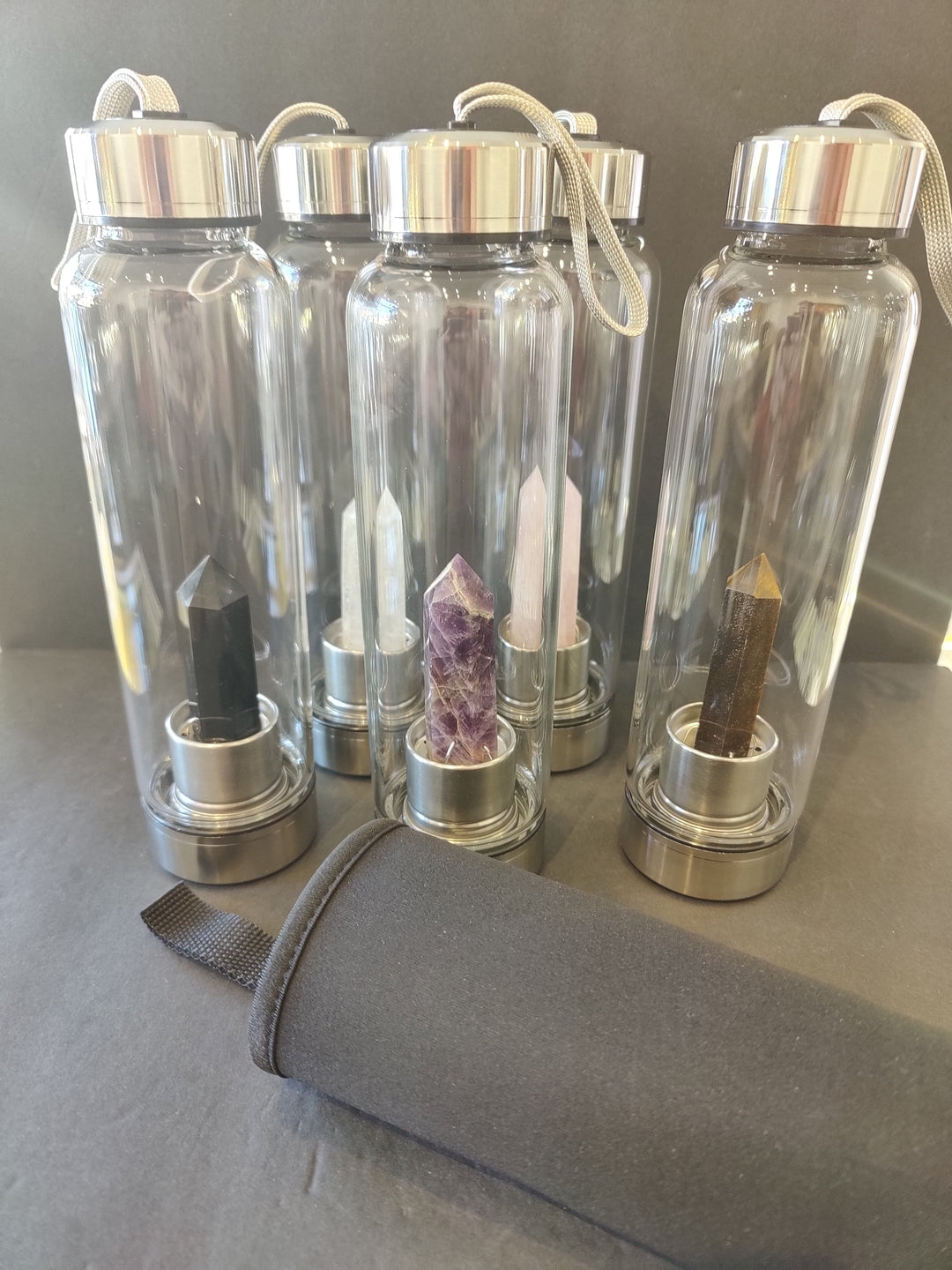 Crystal-infused glass water bottles with stainless steel lids and crystal accents