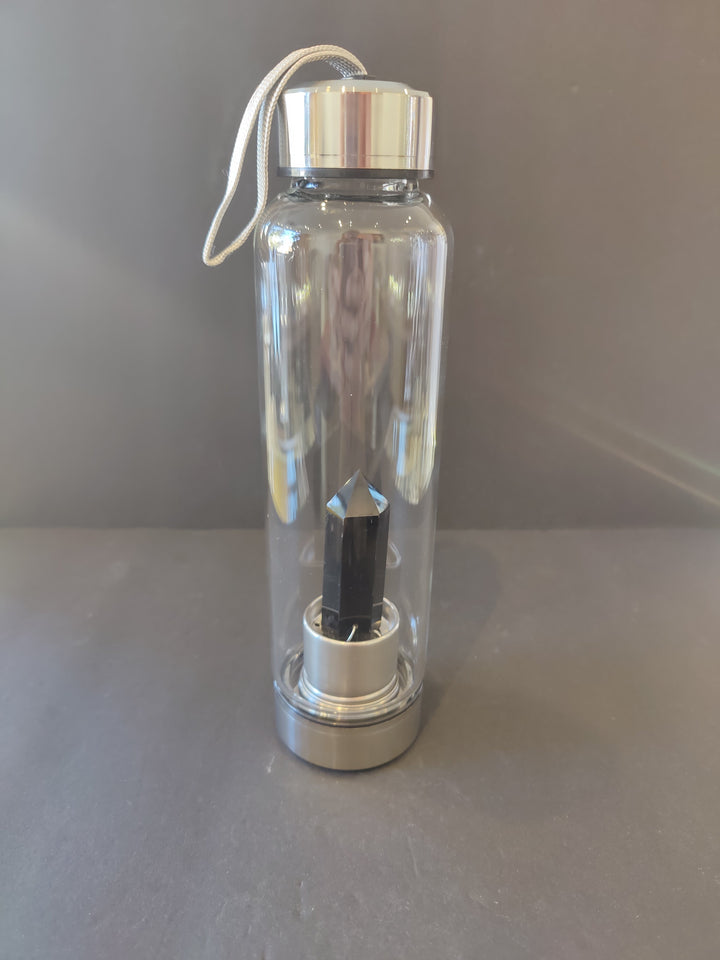 Crystal-infused glass water bottle with stainless steel cap and dark crystal insert