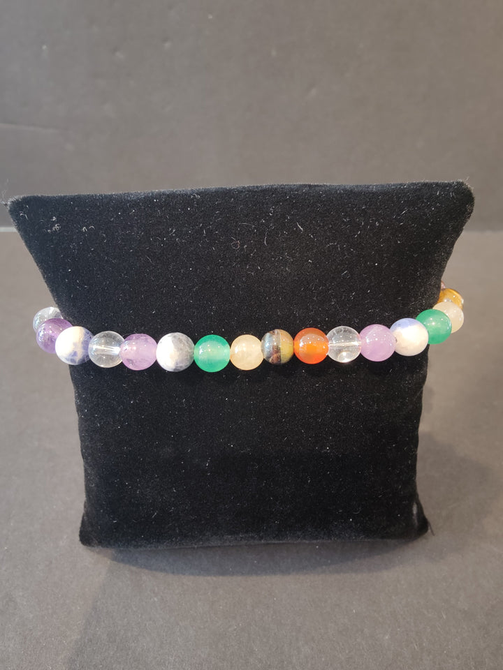 Beaded stone bracelet with 6mm multicolor round beads and clear accent beads.