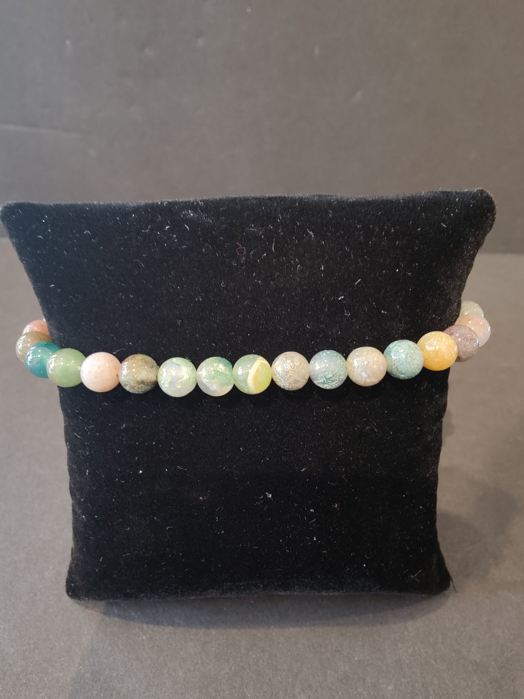 Beaded stone bracelet with 6mm pastel striped round beads and stretch cord.
