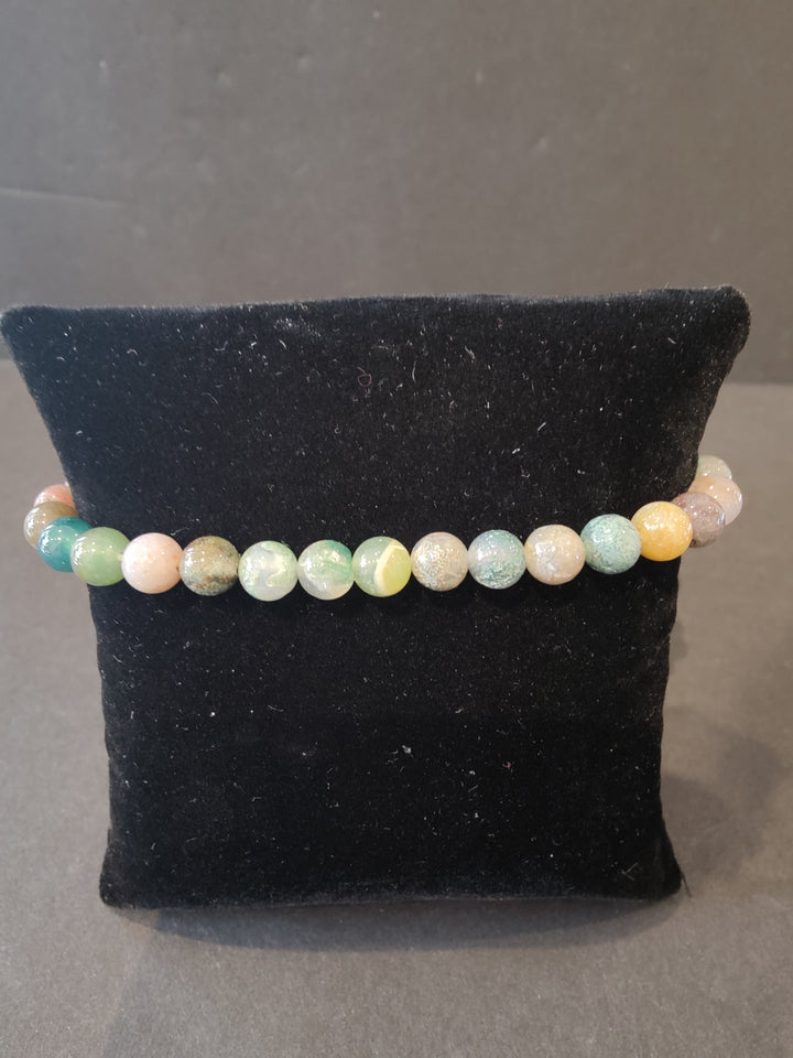 Beaded stone bracelet with 6mm pastel striped round beads and stretch cord.