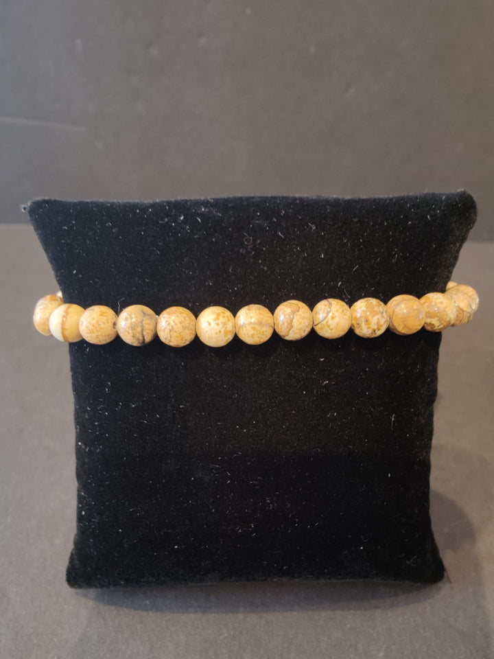 Beaded stone bracelet with 6mm golden tan round beads and stretch cord.