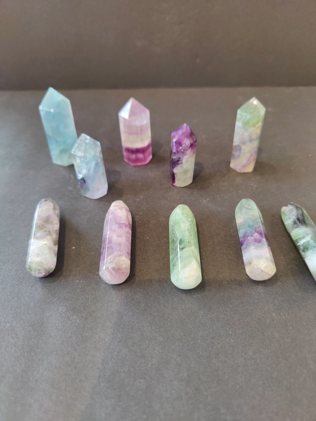 Fluorite crystal points set, pastel blue, pink, purple, and green with faceted obelisk shapes