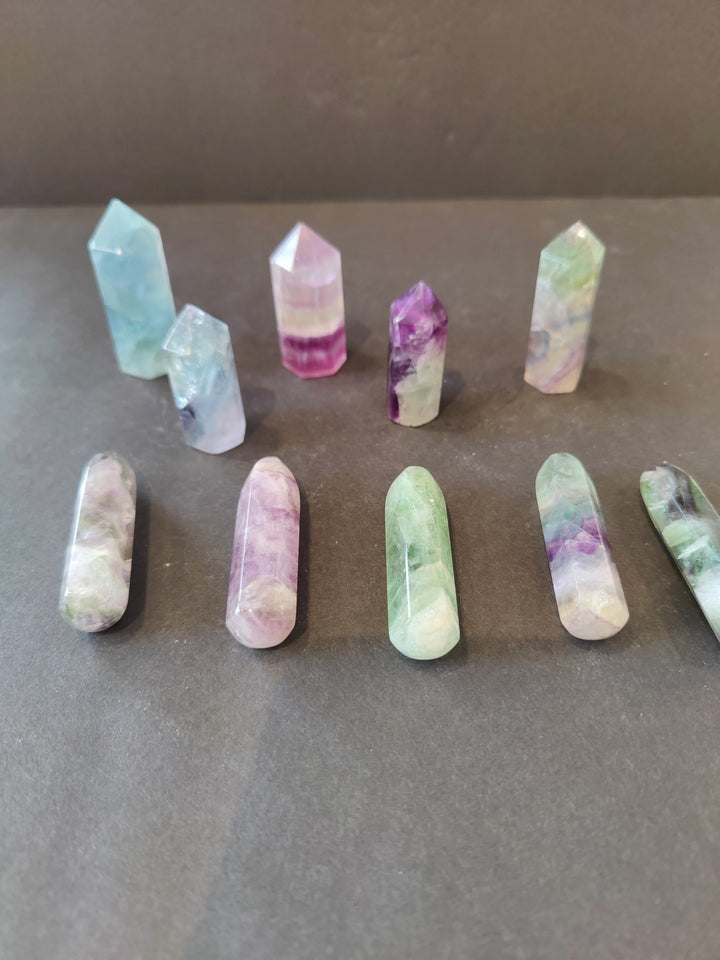 Fluorite crystal points set, pastel blue, pink, purple, and green with faceted obelisk shapes