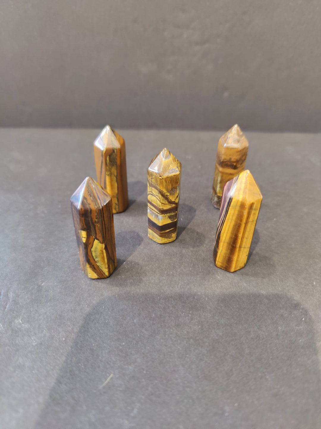 Tiger Eye crystal tower sculpture, faceted golden stone with pointed tops