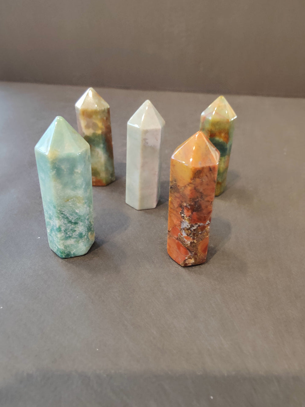 Crystal tower sculpture set in mint, white, and orange with faceted points