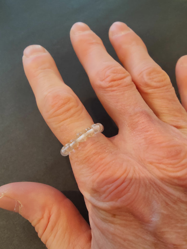 Beaded stone ring with clear 4mm beads on a hand.