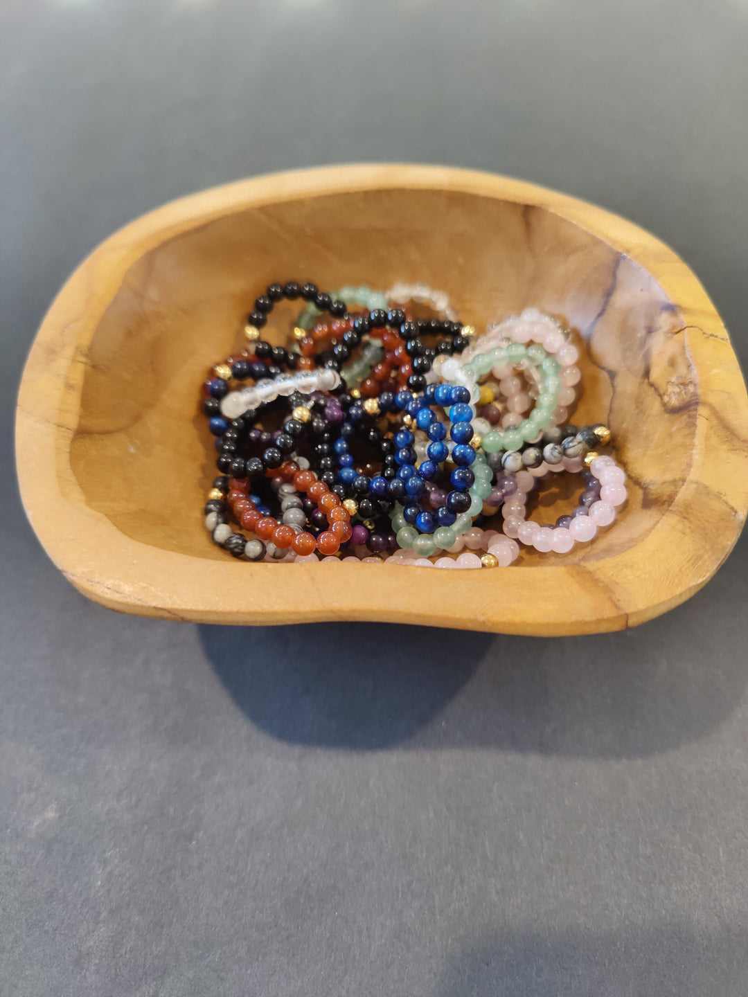 Beaded stone ring with multicolor 4mm beads in black, blue, red, and pink.