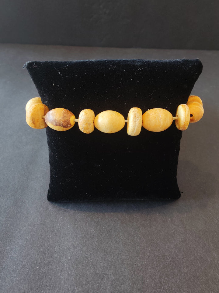 Tan wood beaded bracelet with mixed round and oval beads, stretchy string closure