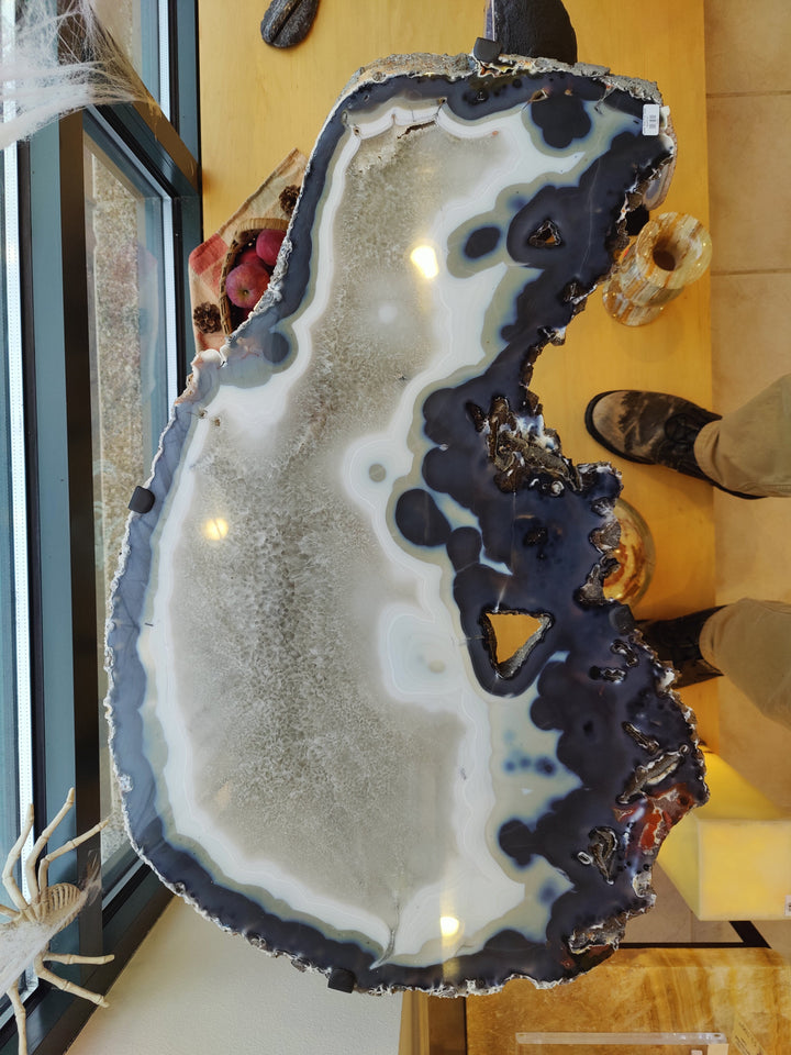 Agate slab end table with tall white-and-blue agate slice top and black metal base