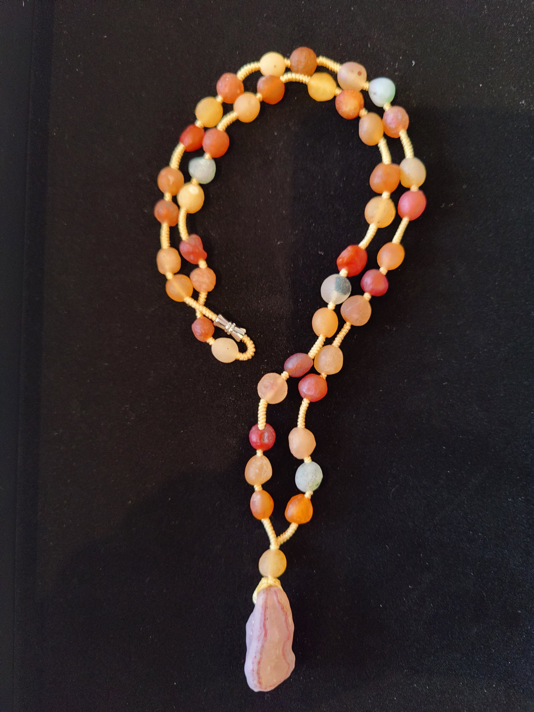 Long agate bead necklace with multicolor beads and pink teardrop pendant