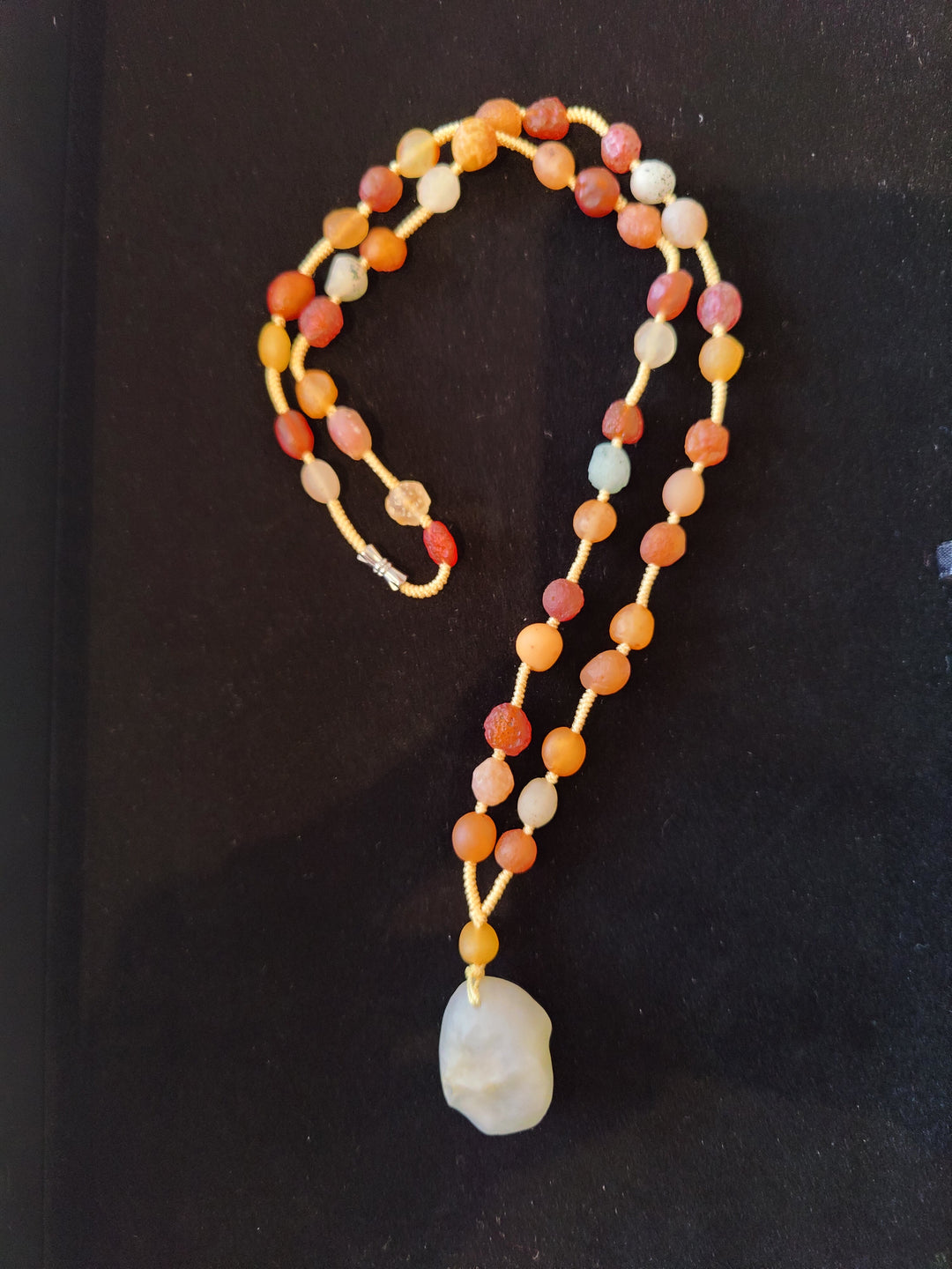 Long multicolor agate bead necklace with single teardrop pendant at center