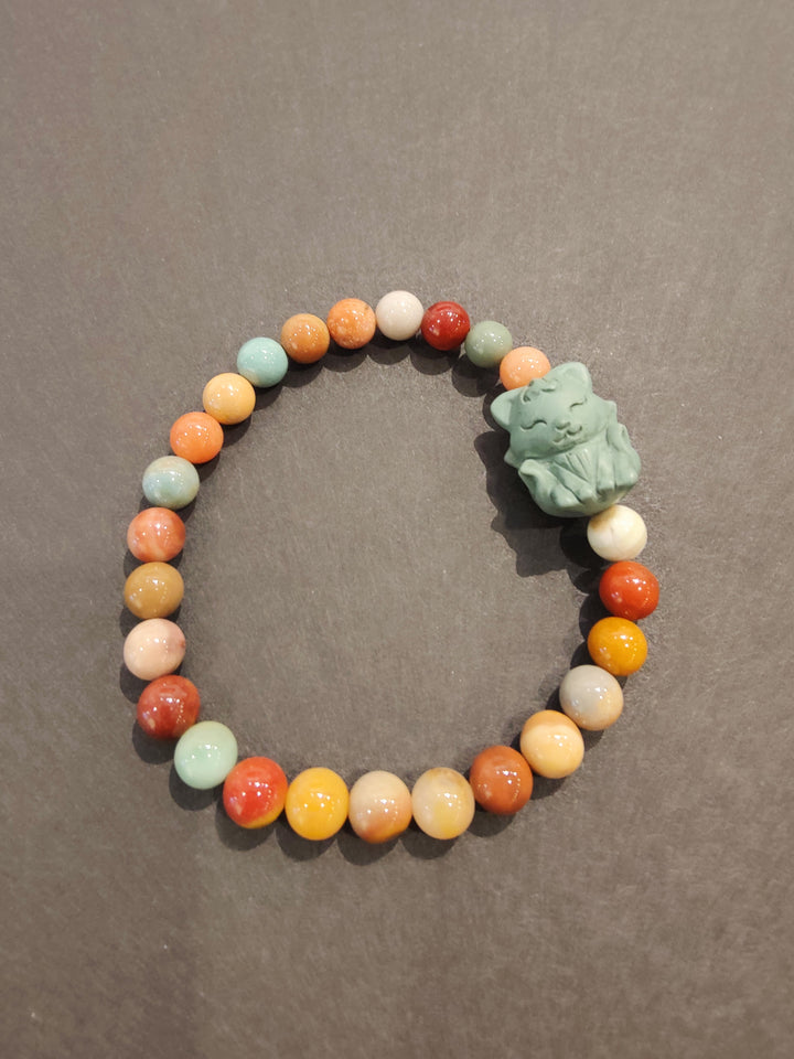 Multi-color bead bracelet with green animal face charm