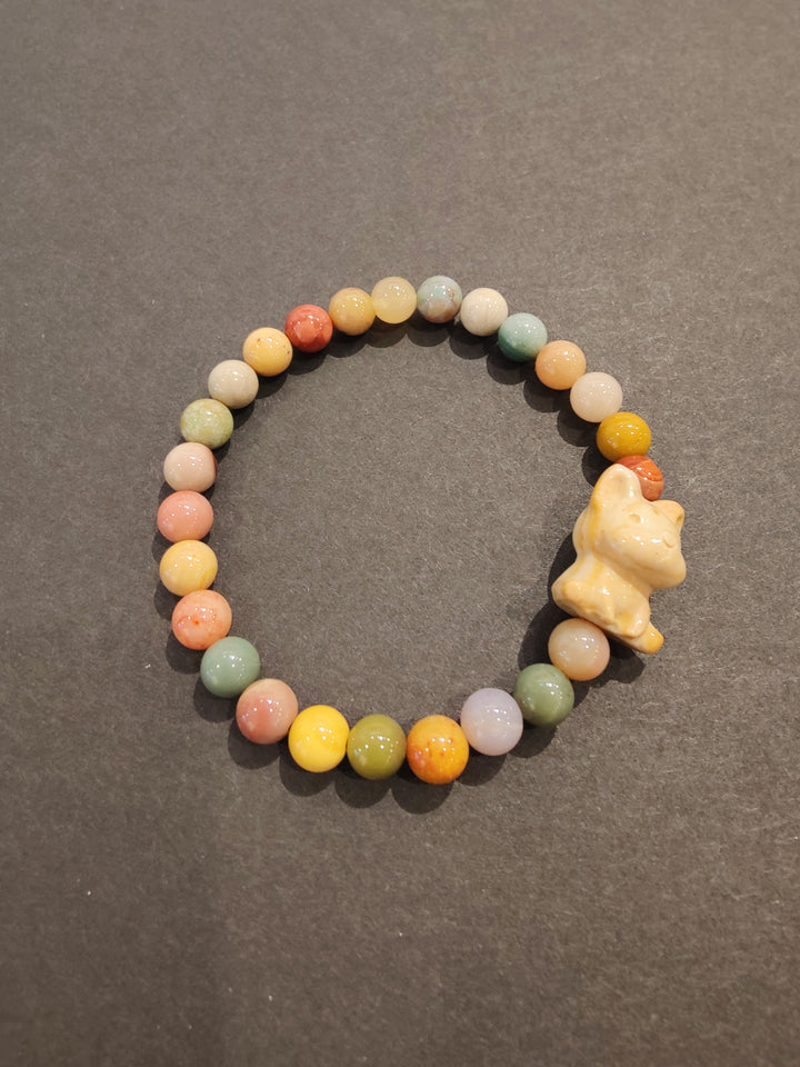 Multi-color bead bracelet with tan animal figurine charm