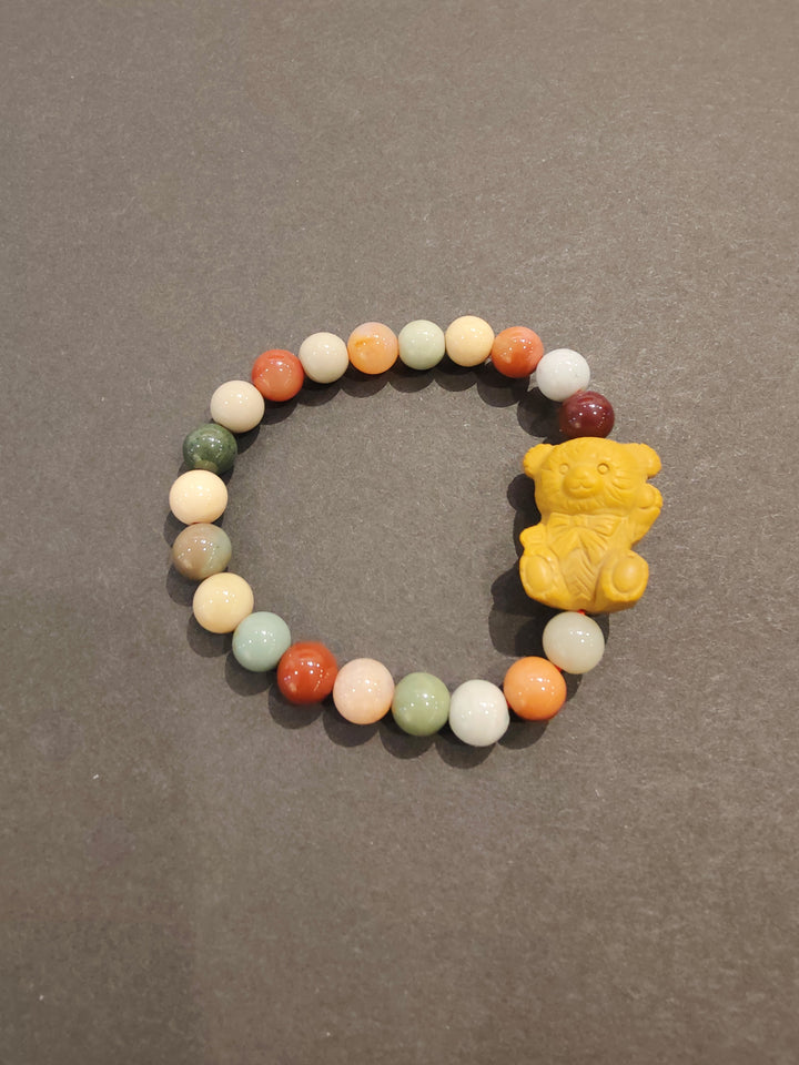 Multi-color bead bracelet with yellow animal face charm