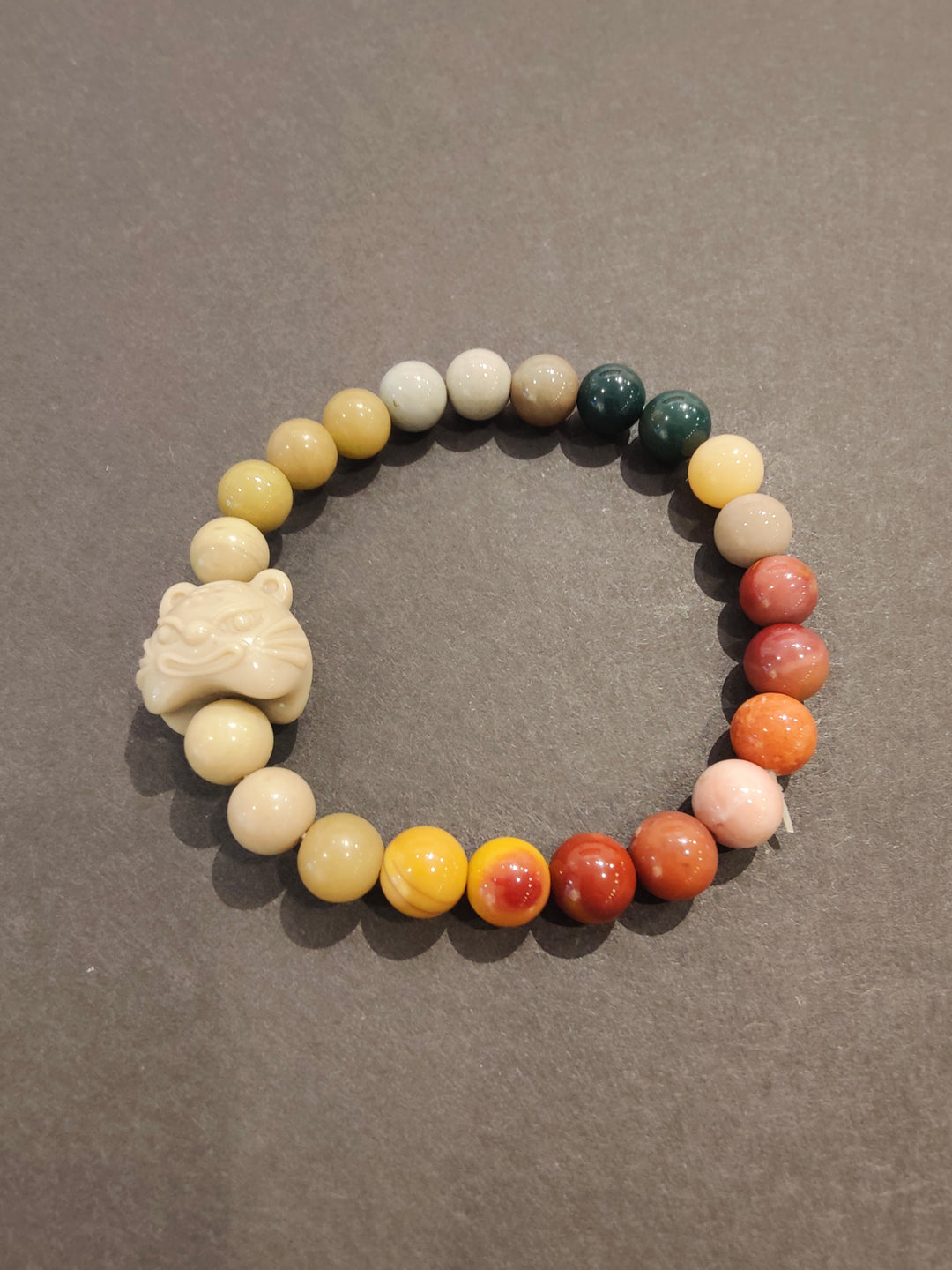 Multi-color bead bracelet with white animal charm