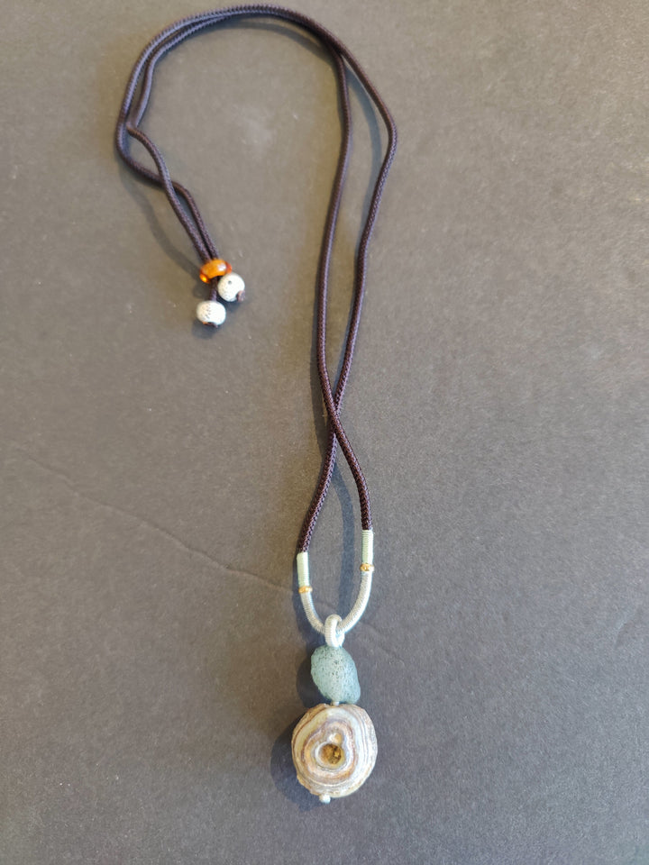 Eye agate pendant necklace with small bead accents and swirl stone on dark cord