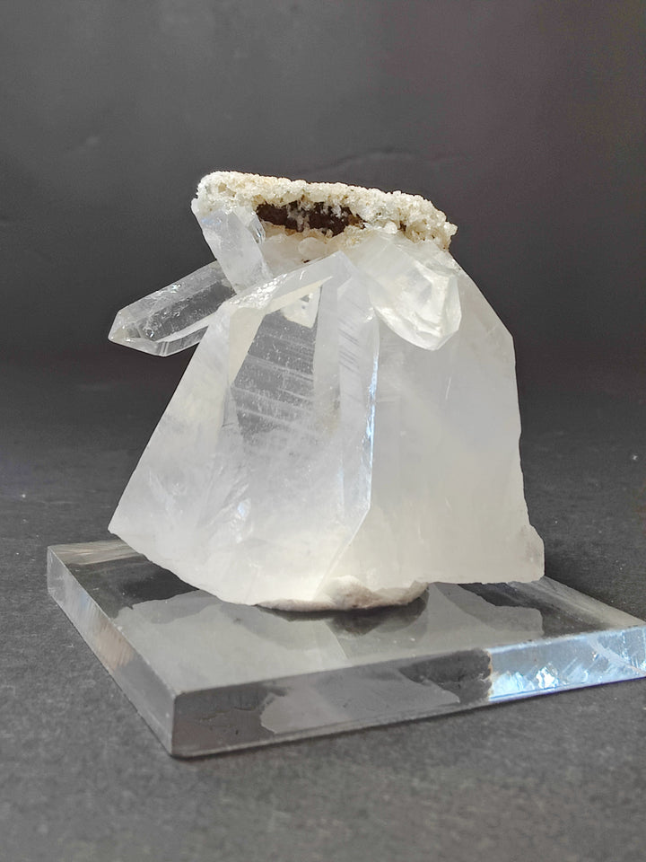 Quartz crystal point cluster on clear base; white crystals with tan druzy on top