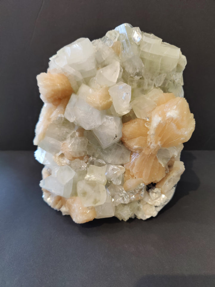 Apophyllite mineral specimen with white and peach crystal clusters