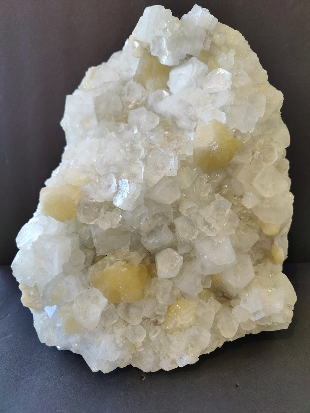 Clear apophyllite and stilbite crystal cluster with white and pale yellow points