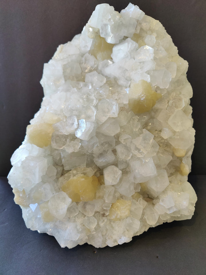 Clear apophyllite and stilbite crystal cluster with white and pale yellow points