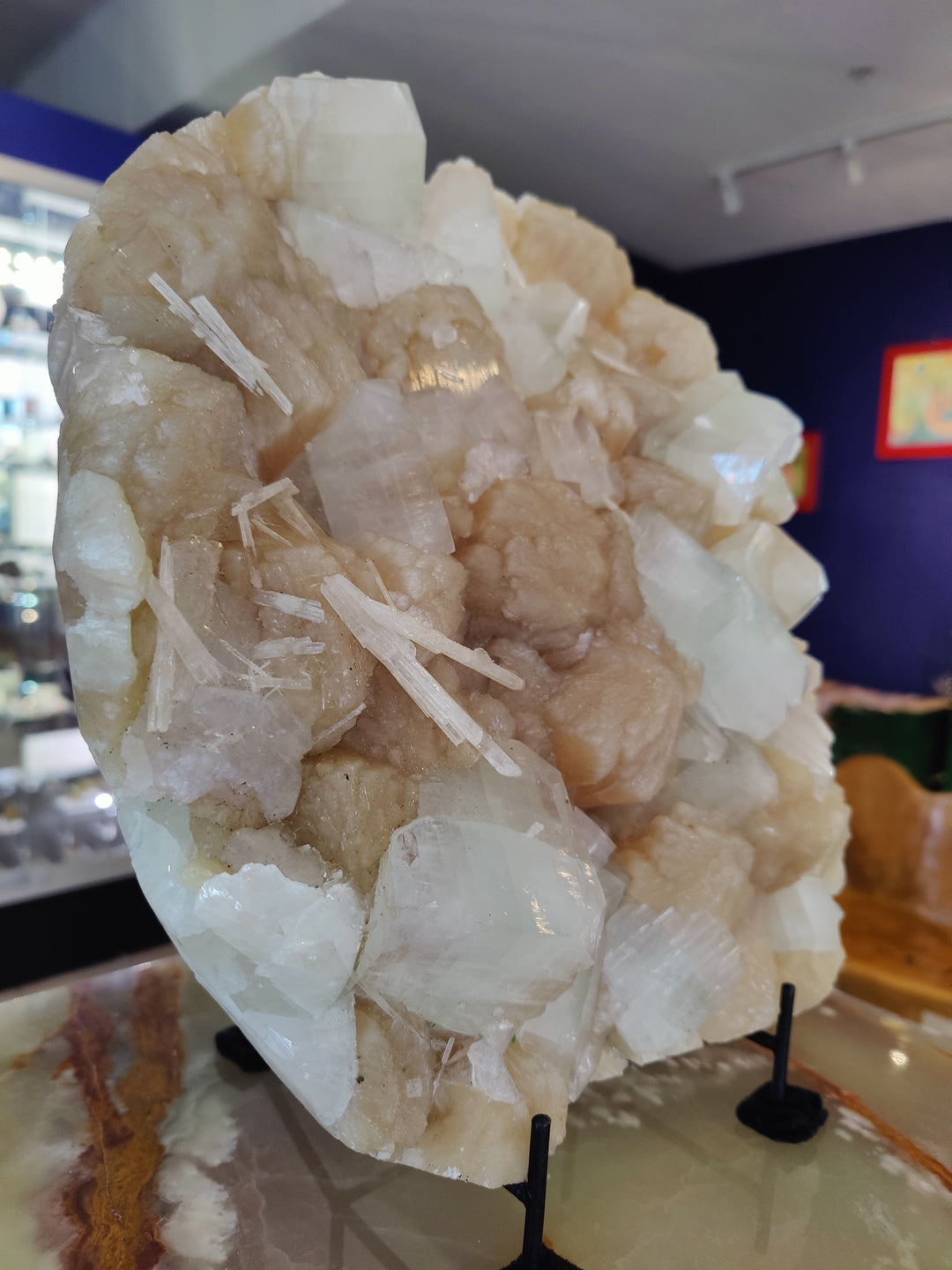 Large crystal cluster specimen with clear white blades and pale beige core on stand