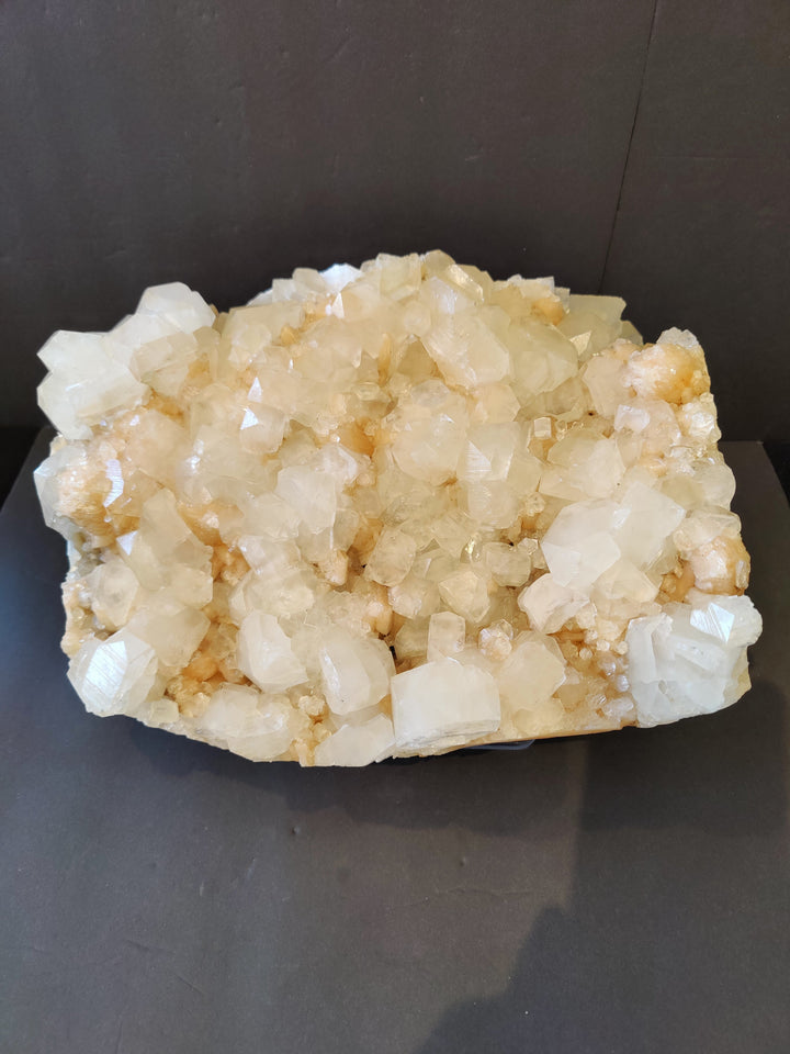 Mineral crystal cluster specimen with clear white and peach-toned crystals