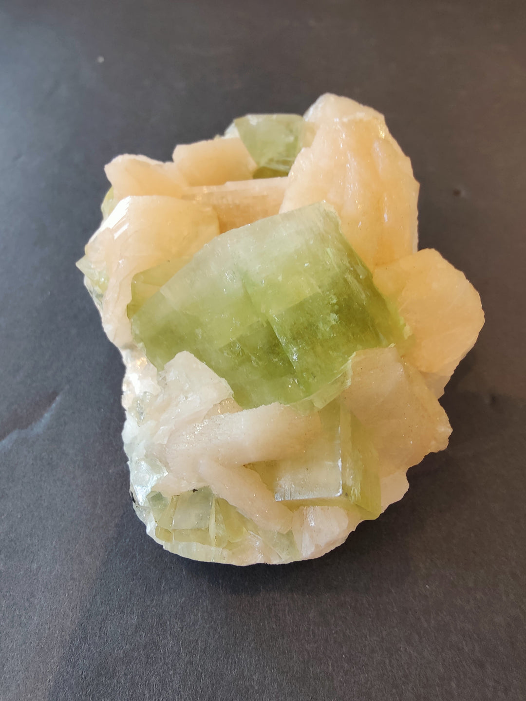 Pale green and peach mineral crystal cluster with sharp cube facets