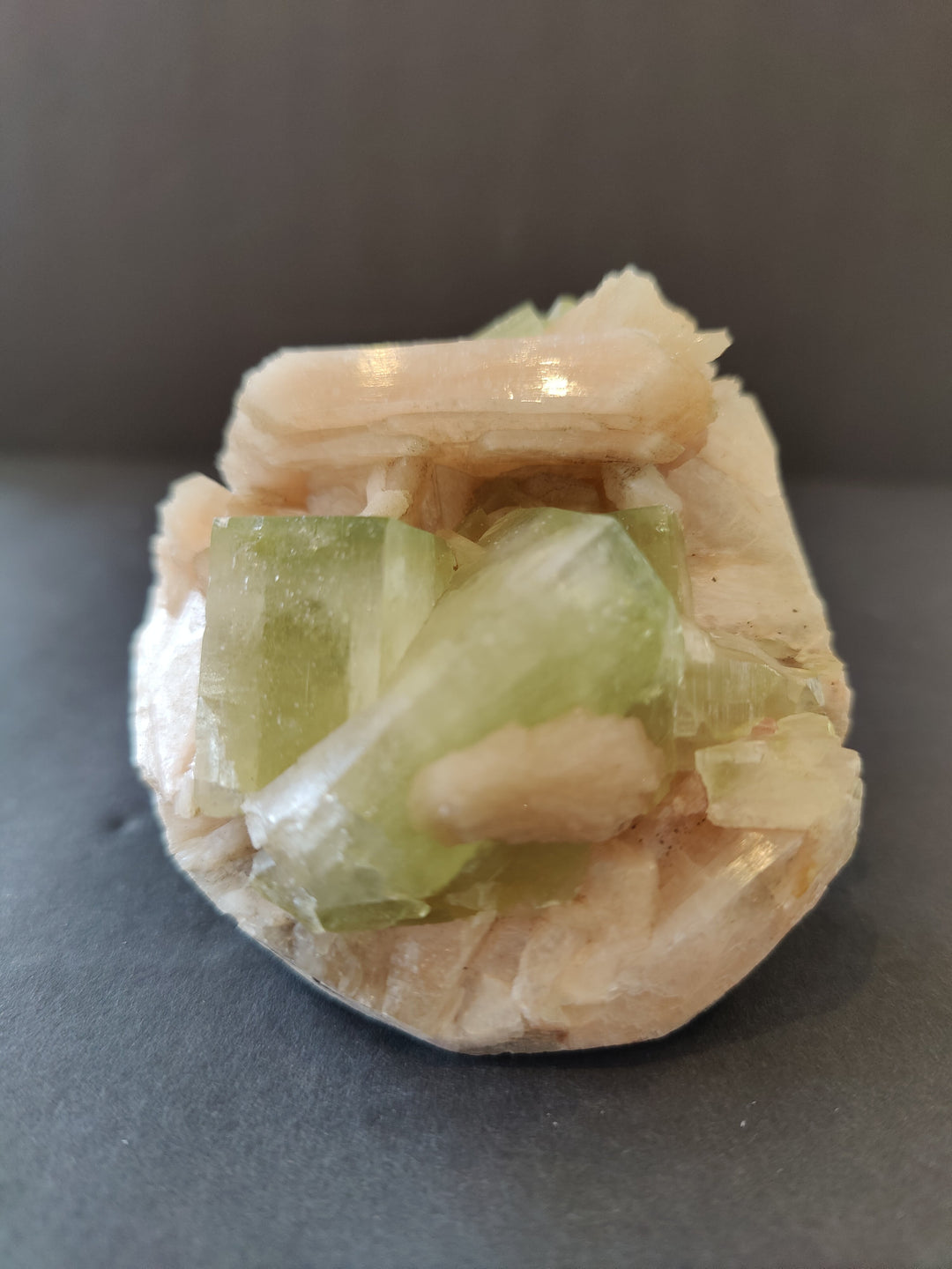 Green and peach mineral crystal specimen with translucent cube clusters