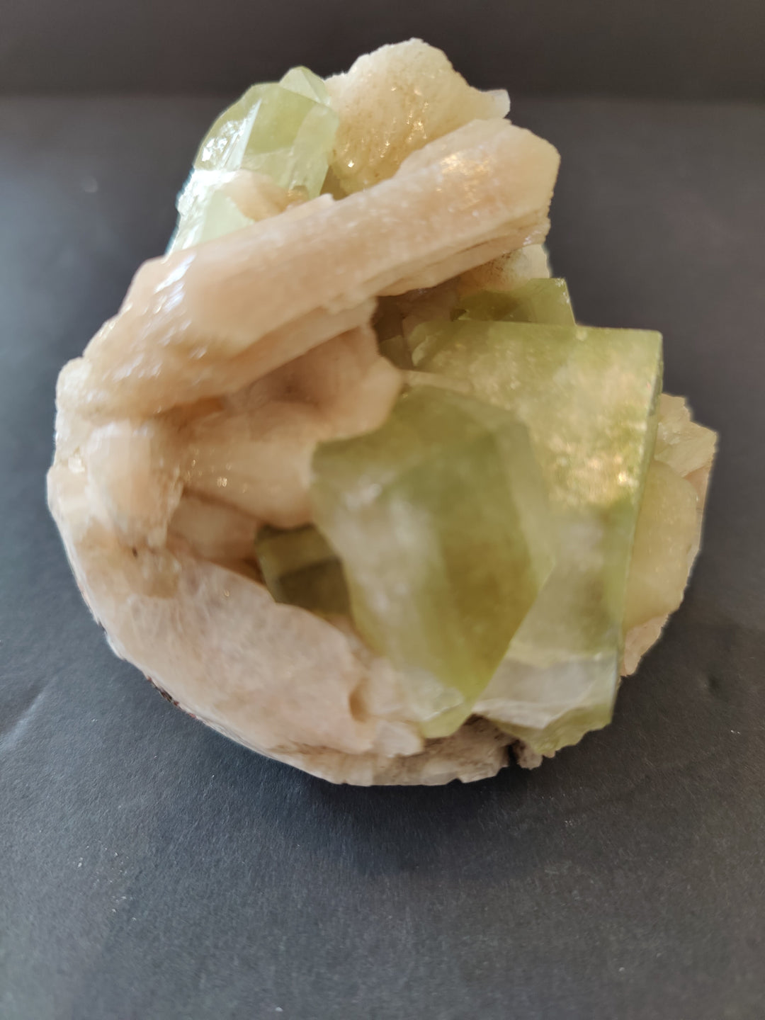 Green and peach mineral specimen featuring translucent cube crystals and beams