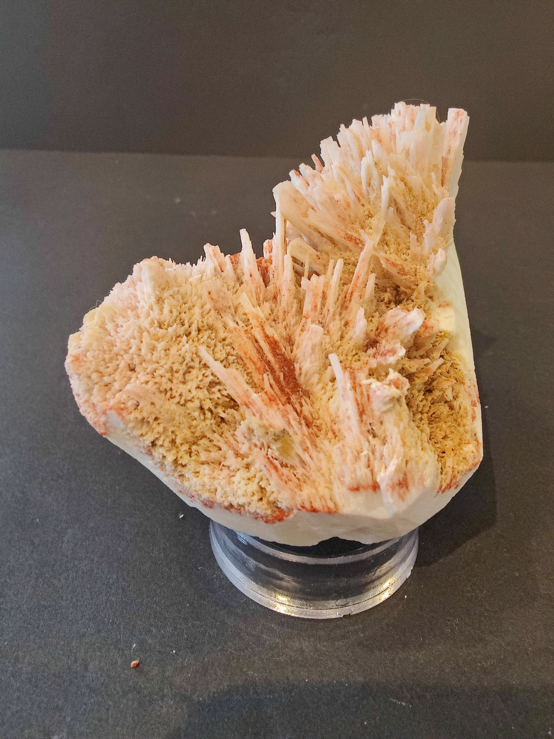 Peach and white mordenite crystal cluster specimen on metal display base