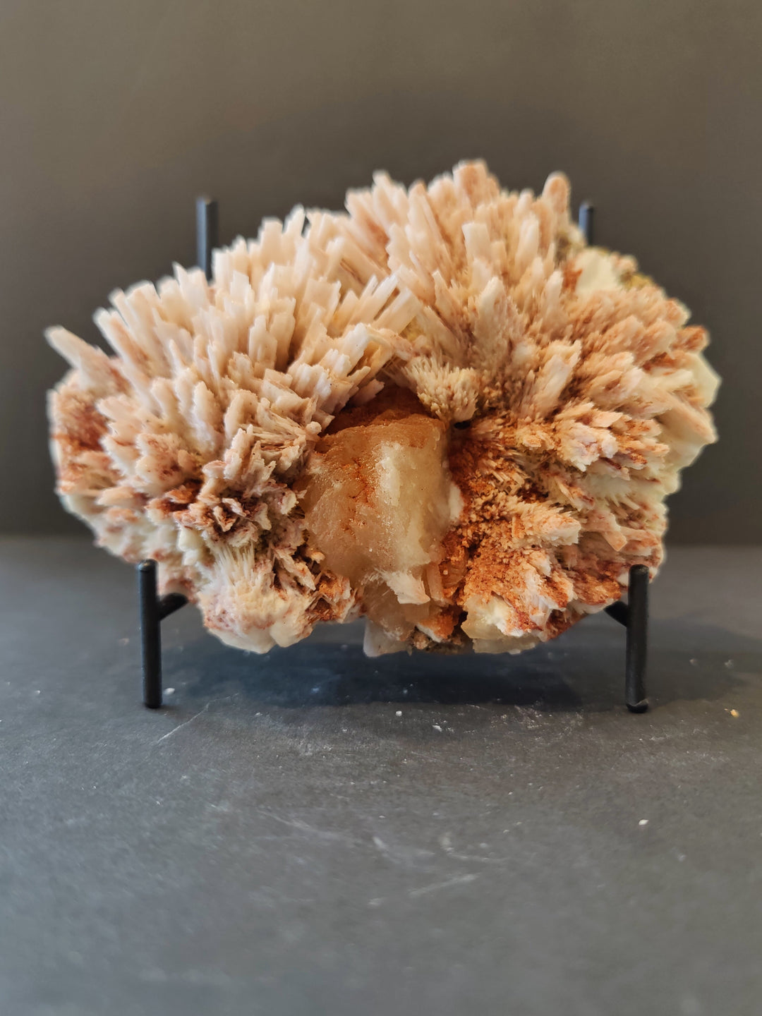 Mordenite with stilbite mineral specimen, beige crystal cluster on black stand