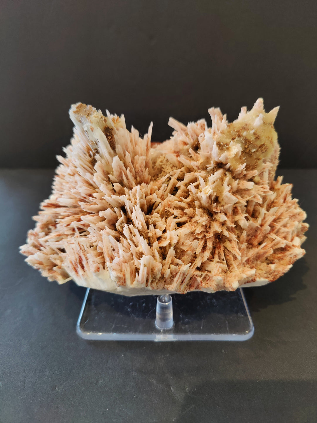 Red mordenite and stilbite crystal cluster on clear stand.