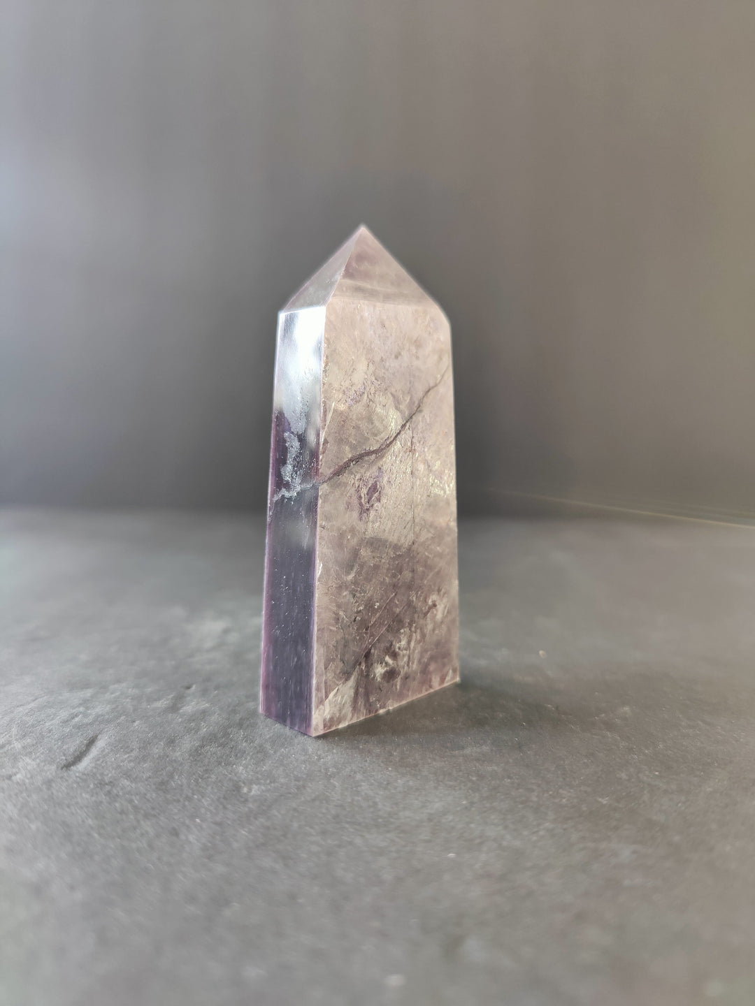 Lepidolite tower sculpture, tall faceted prism with pale pink and gray veining