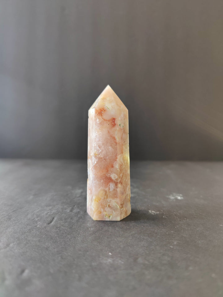 Polished peach-and-cream flower agate crystal tower with marbled pattern