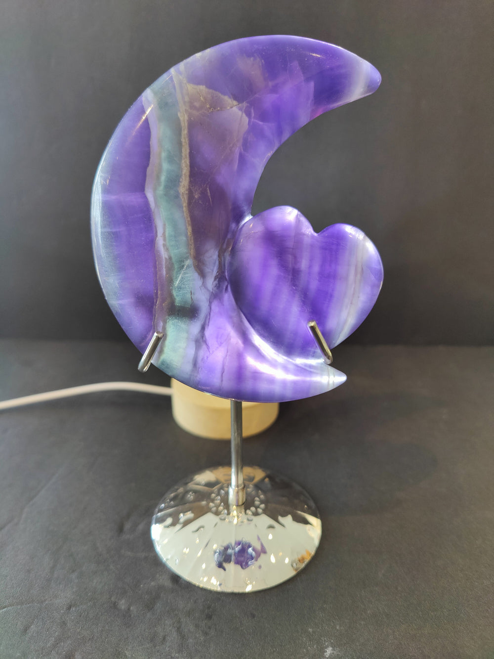 Purple fluorite half-moon sculpture with heart accent, on a 5 in metal stand
