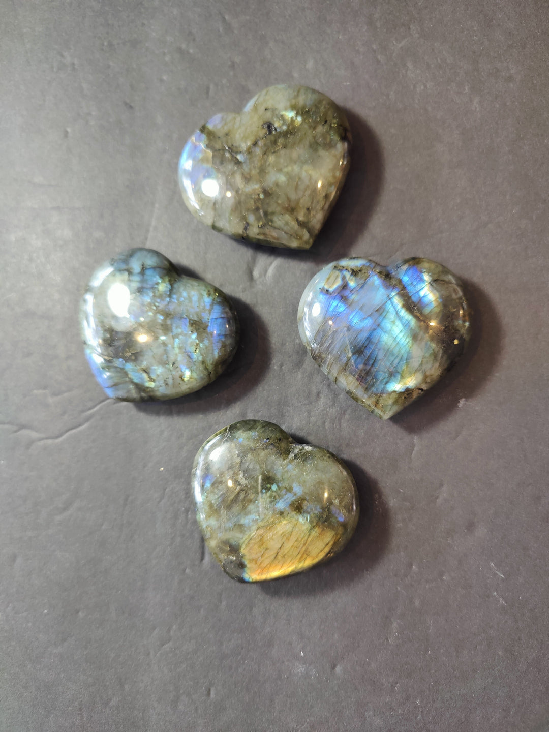 Polished labradorite heart with green-gold base and bright blue iridescent flash