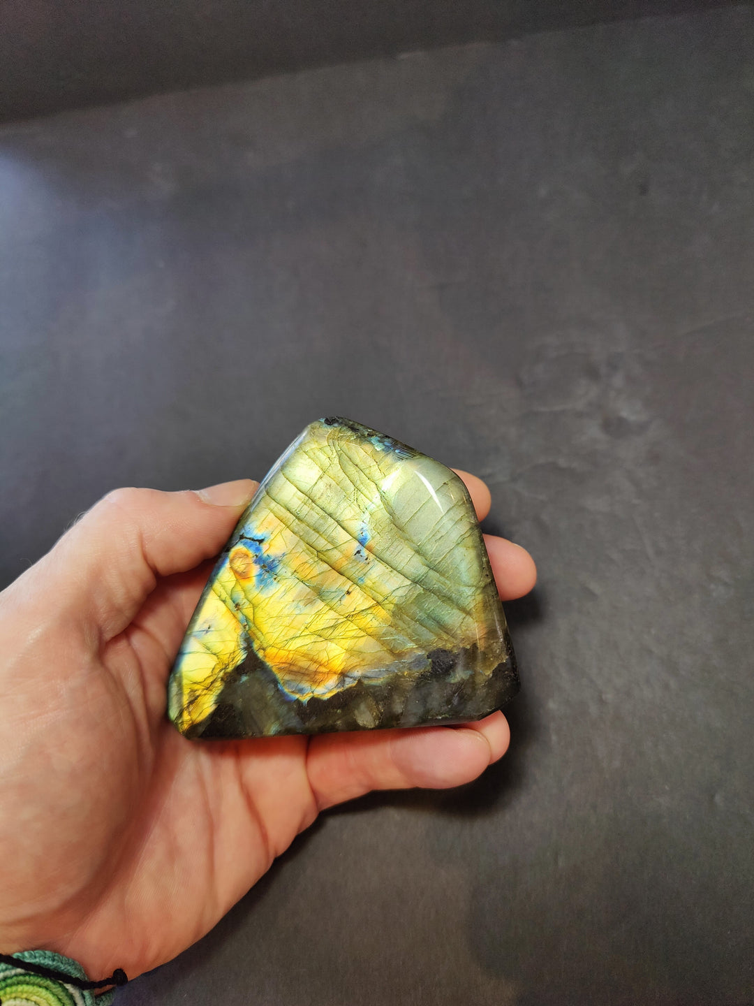Polished labradorite freeform sculpture, lime green with yellow flash and dark edge