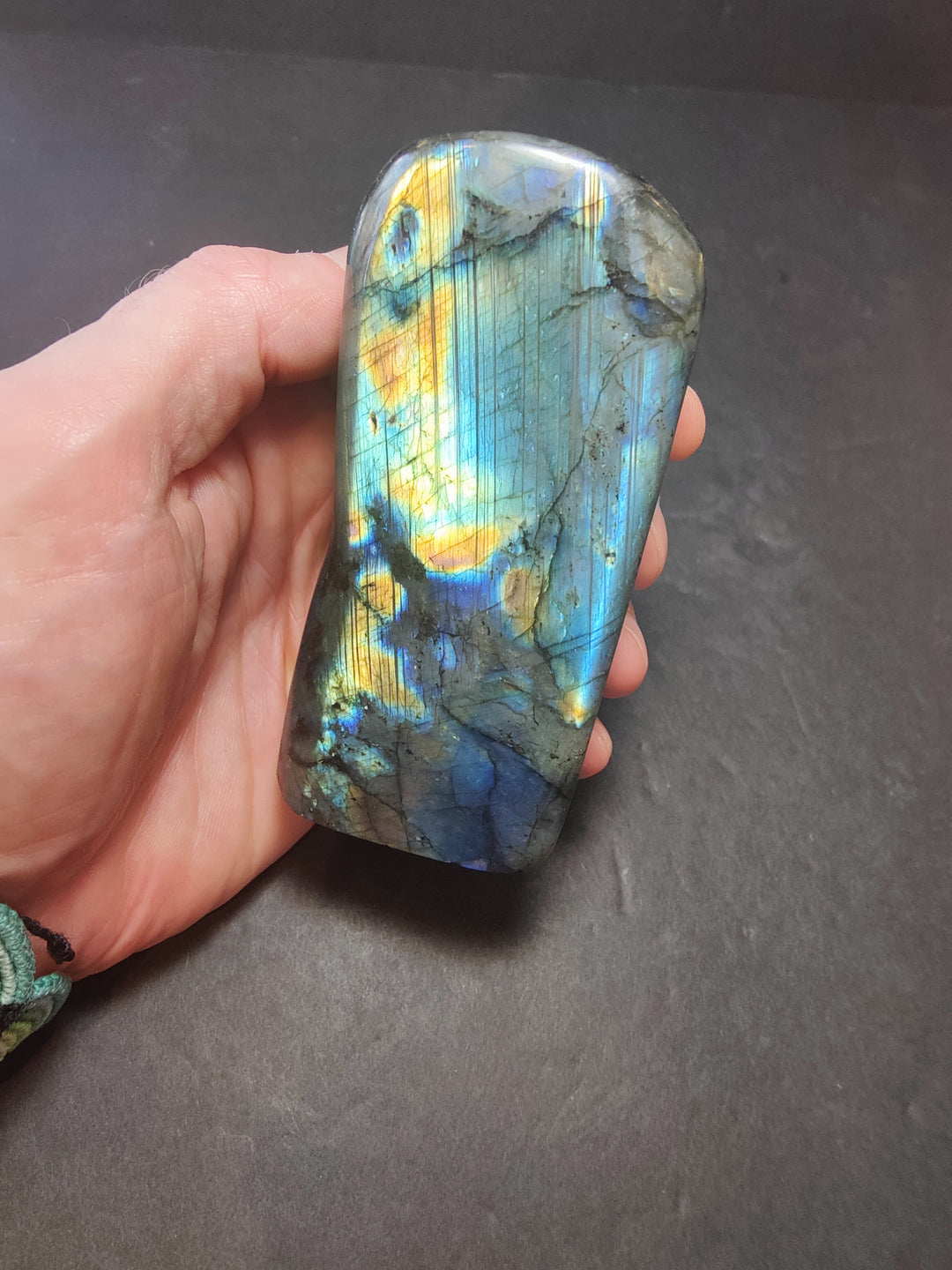 Polished labradorite freeform sculpture, light blue with gold flare and dark gray patches
