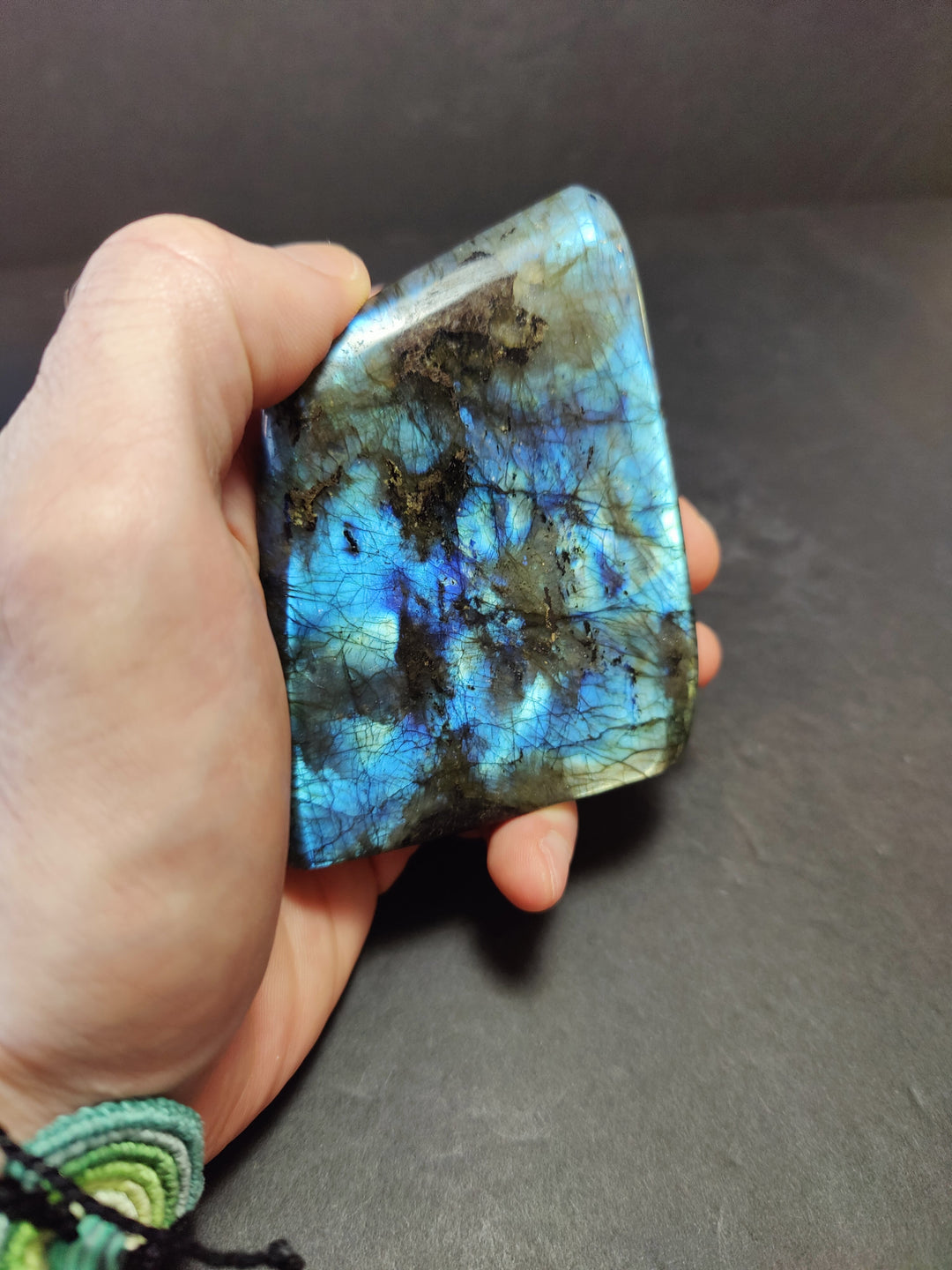 Polished labradorite freeform sculpture, turquoise with dark inclusion and electric blue flash