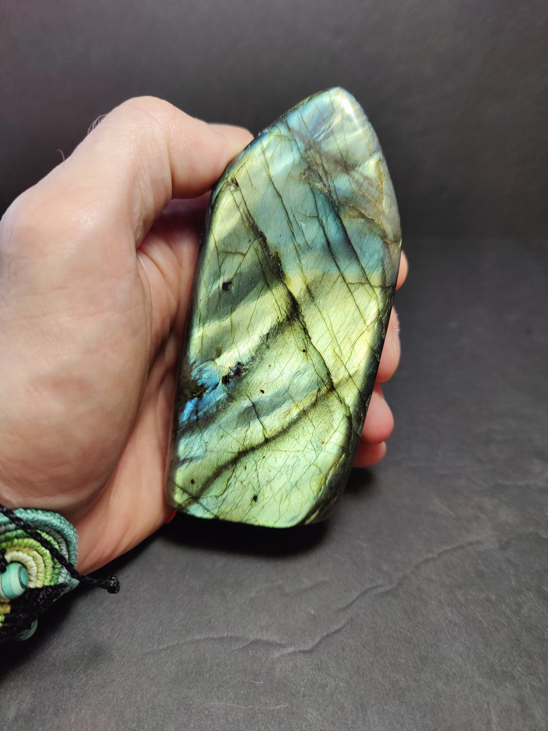 Polished labradorite free-form sculpture with green-blue iridescence