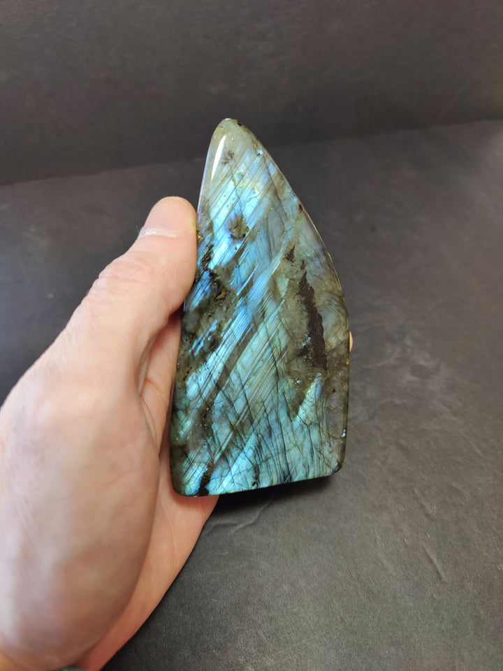 Polished labradorite free-form sculpture with blue iridescent sheen