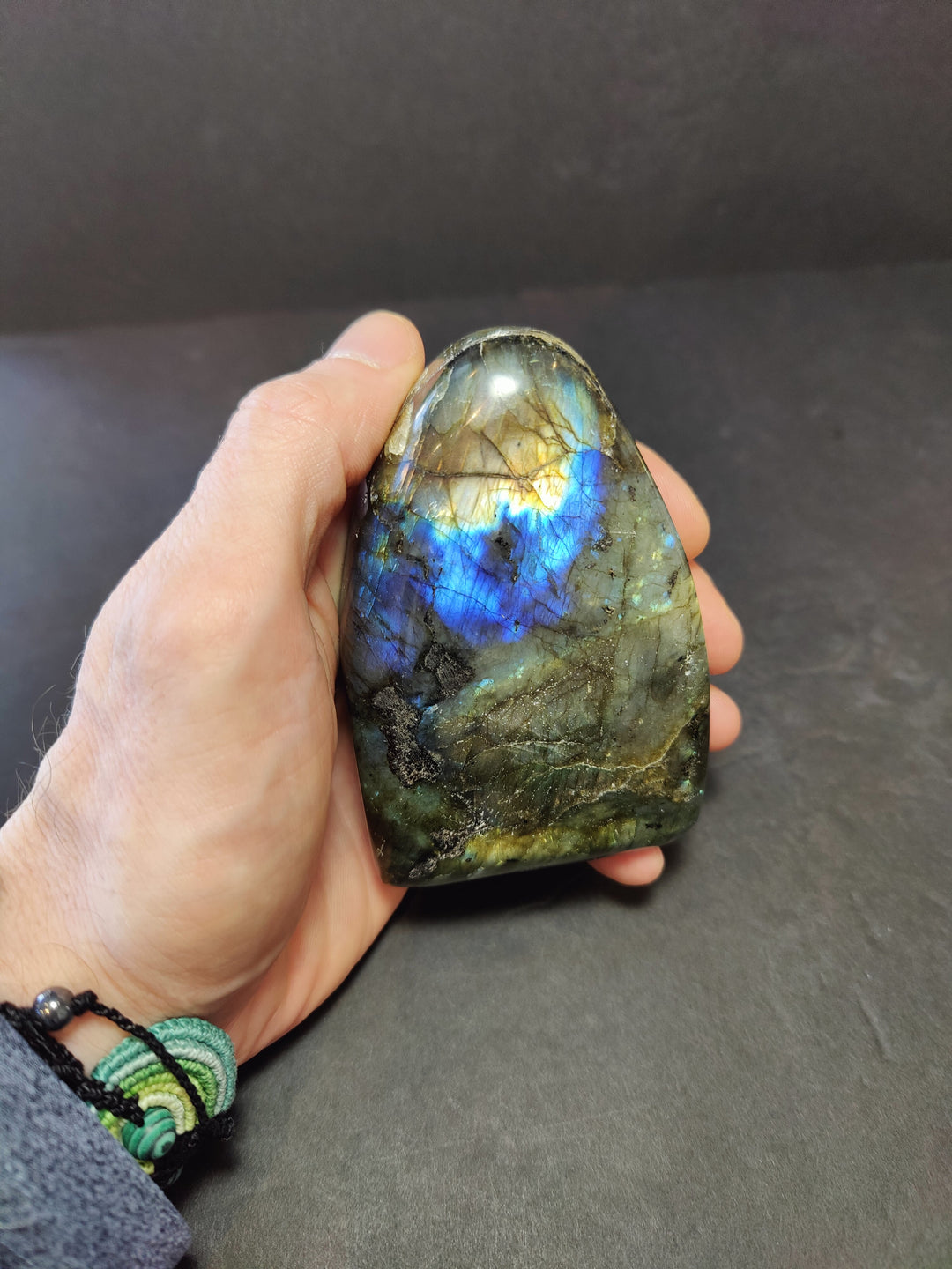Polished labradorite free-form sculpture with deep blue flash and gold tones