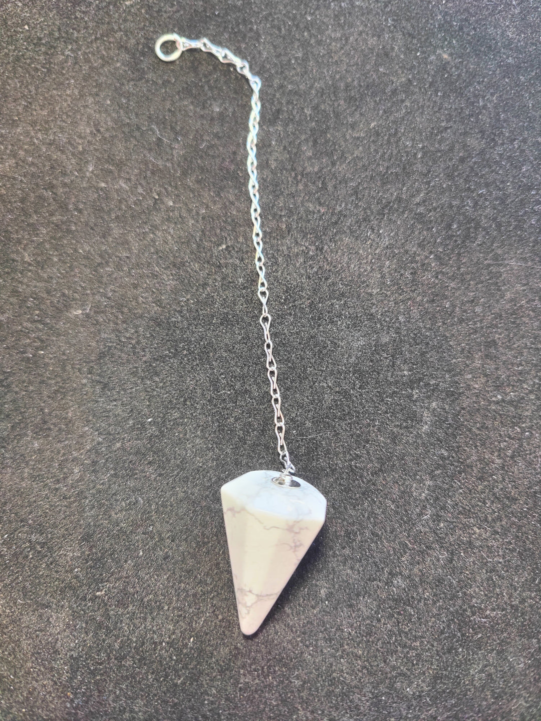 White and pale pink stone pendulum on silver chain with round clasp ring
