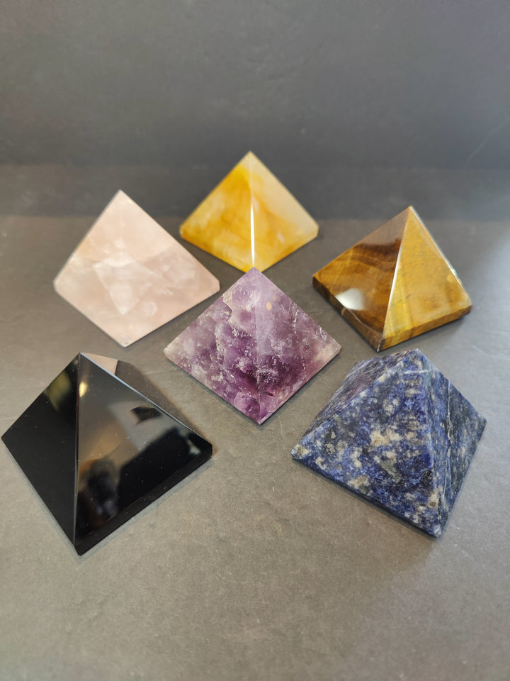 Polished stone pyramid sculptures assortment in yellow, white, purple, blue, black