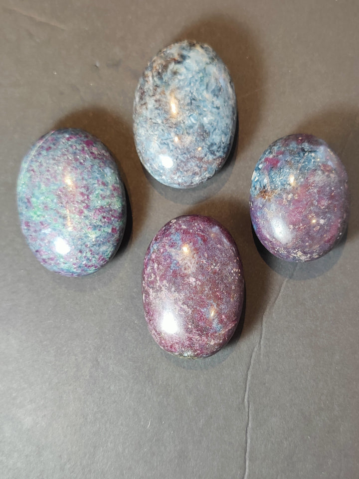 Polished ruby kyanite palmstones set, multicolor ovals in blue, purple, and pink tones