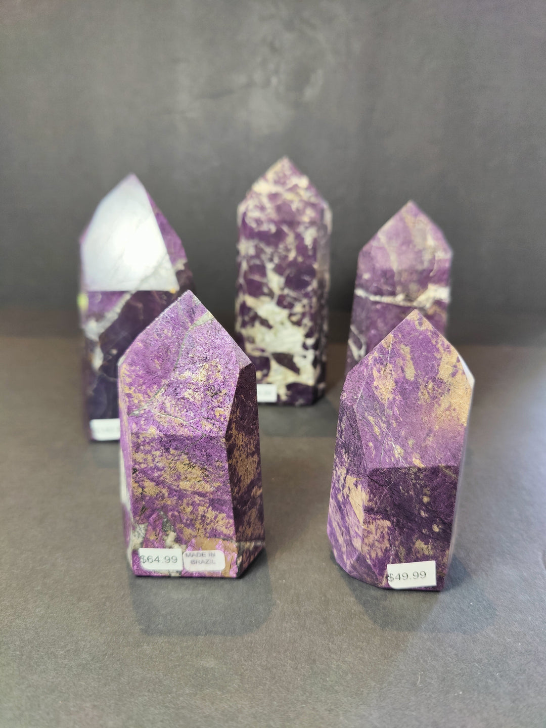 Polished purpurite obelisk tower sculptures, set of three, purple with white veining.