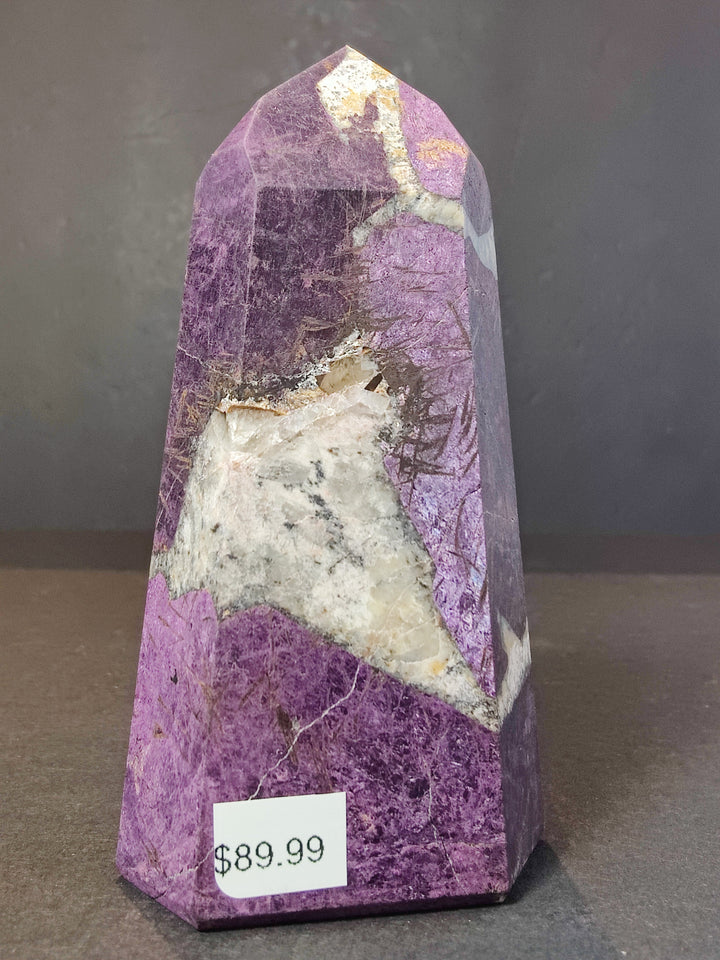 Polished purpurite obelisk tower sculpture in purple with pale crystal veining