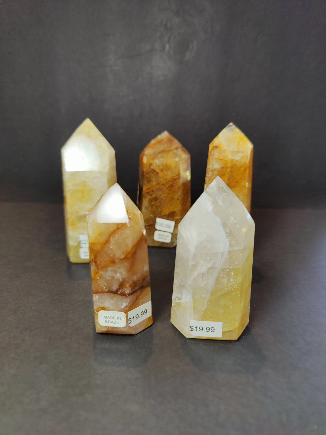 Set of polished yellow quartz obelisk tower sculptures with white crystal points