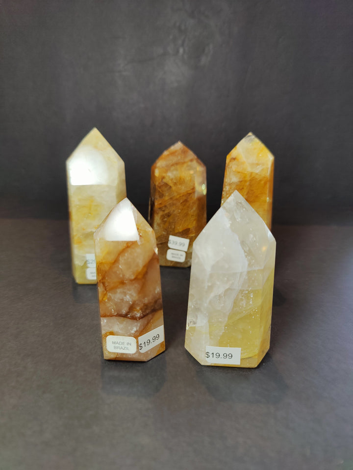 Set of polished yellow quartz obelisk tower sculptures with white crystal points
